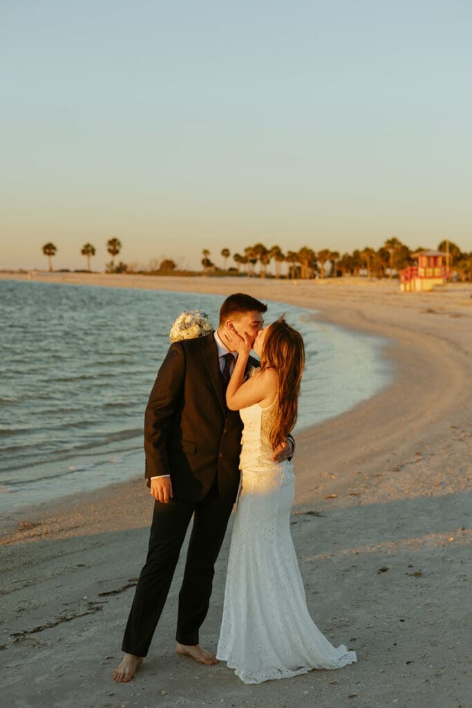 bride and groom running along the beach shore in central florida