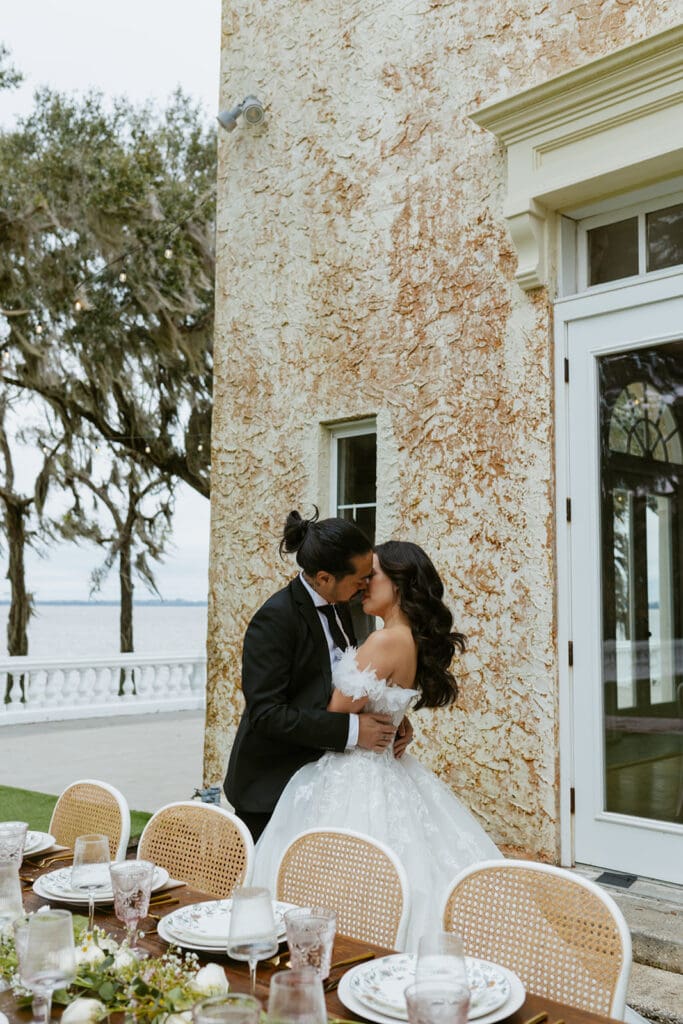 bride and groom in front of the european inspired bella cosa wedding venue