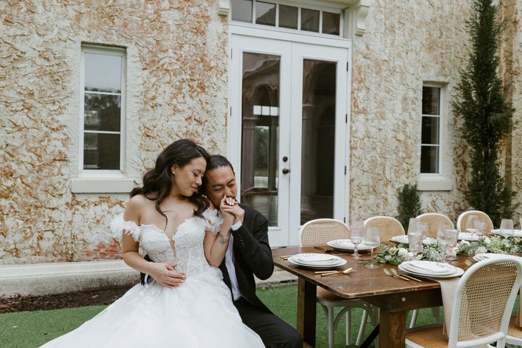 playful couple in front of bella cosa 