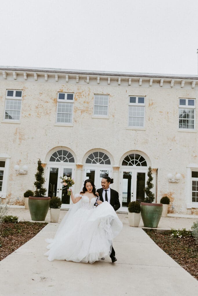 bride and groom in front of the european inspired bella cosa wedding venue