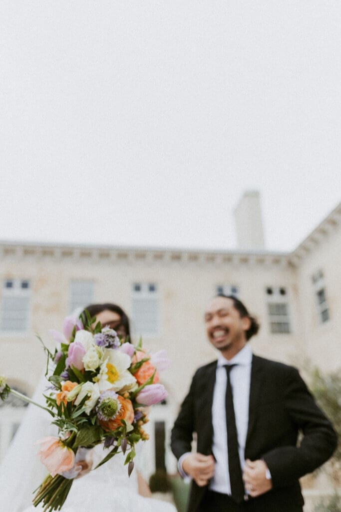 bride and groom in front of the bella cosa wedding venue