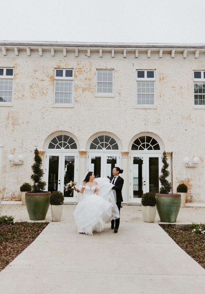 sweet couple in front of the bella cosa wedding venue in florida