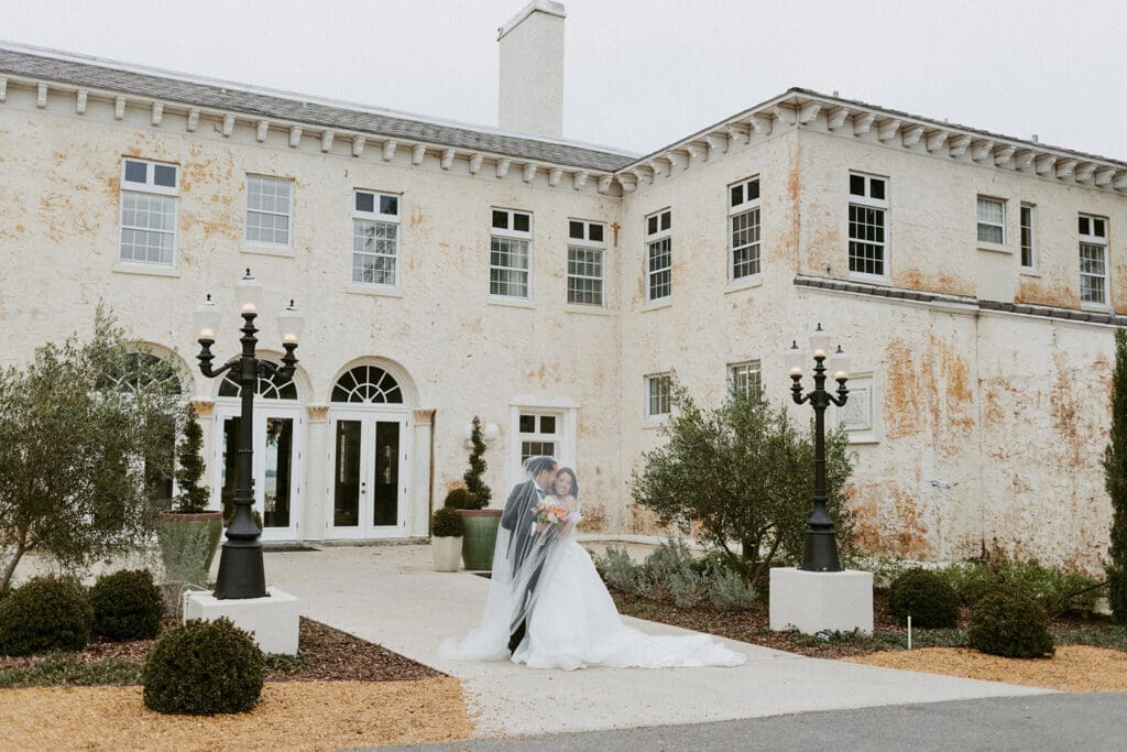 sweet couple in front of the bella cosa wedding venue in florida