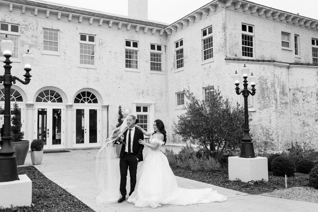 bride and groom in front of the bella cosa wedding venue
