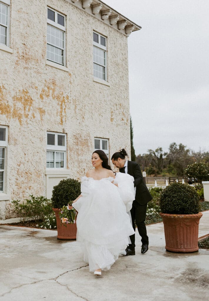 bride and groom in front of the bella cosa wedding venue