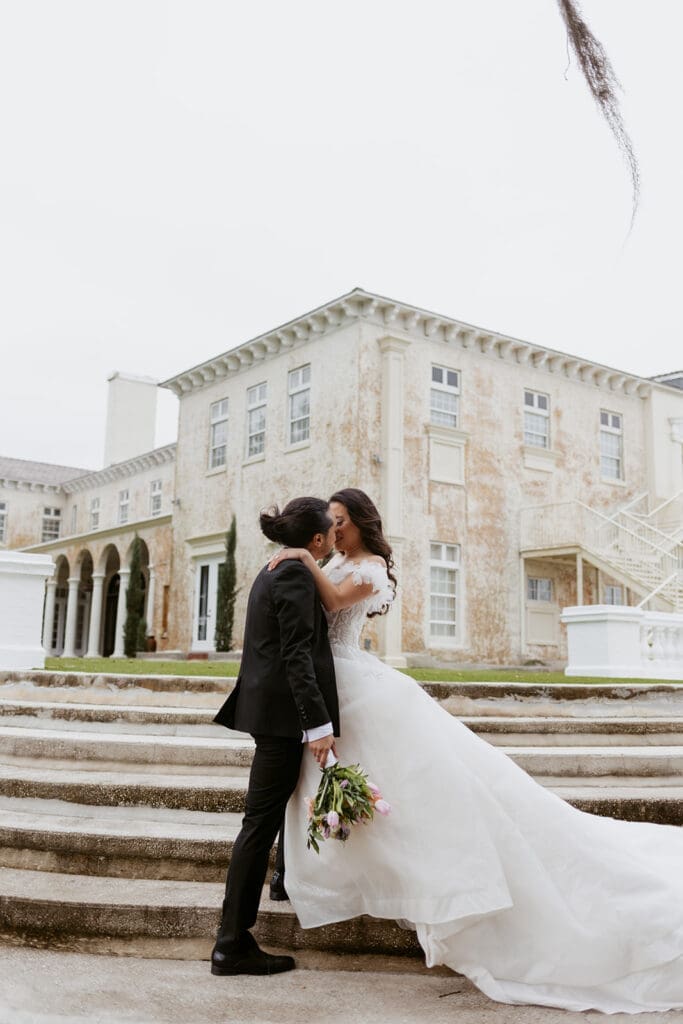 sweet couple in front of the bella cosa wedding venue in florida