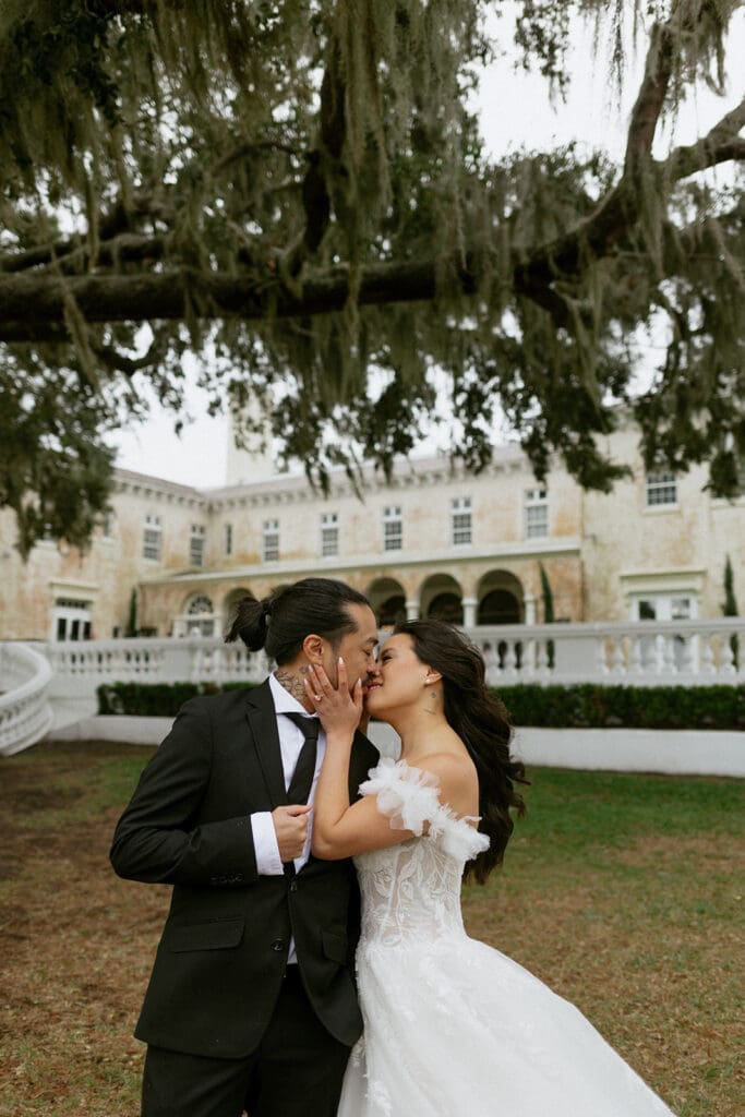 bride and groom in front of the bella cosa wedding venue