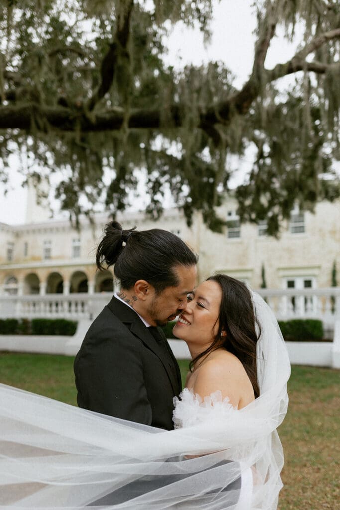 playful couple in front of bella cosa 
