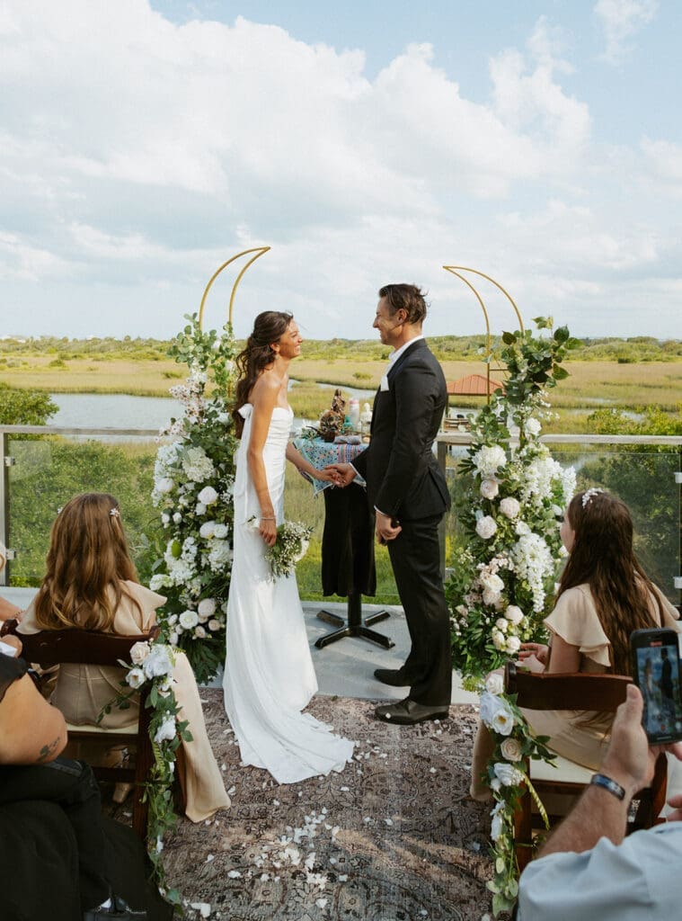 candid elopement ceremony on a balcony overlooking water for a st augustine elopement