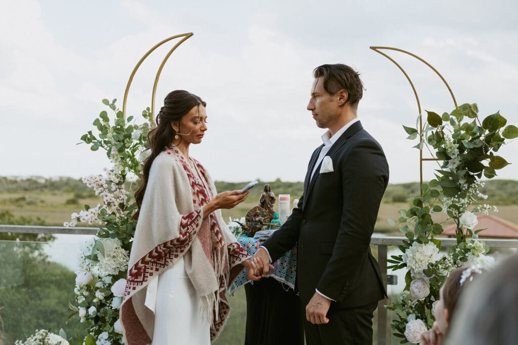 candid elopement ceremony on a balcony overlooking water for a st augustine elopement