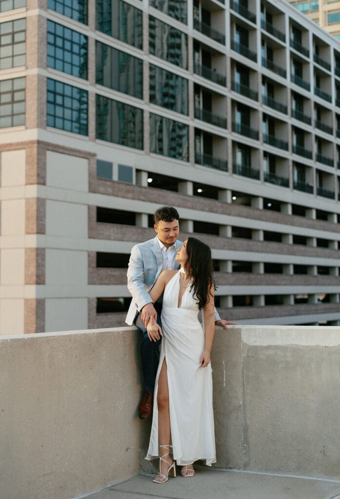 couple hugging with city skyline in the background on a garage rooftop in st pete florida