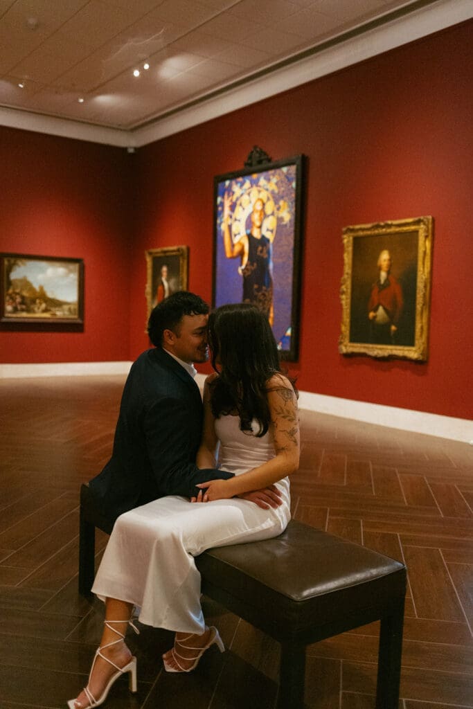 elegant couple gazing at art during their engagement photos at the Museum of fine arts