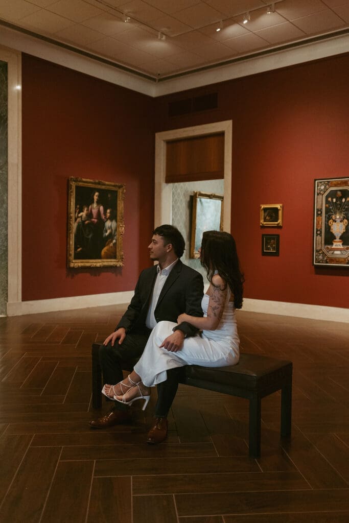 elegant couple gazing at art during their engagement photos at the Museum of fine arts