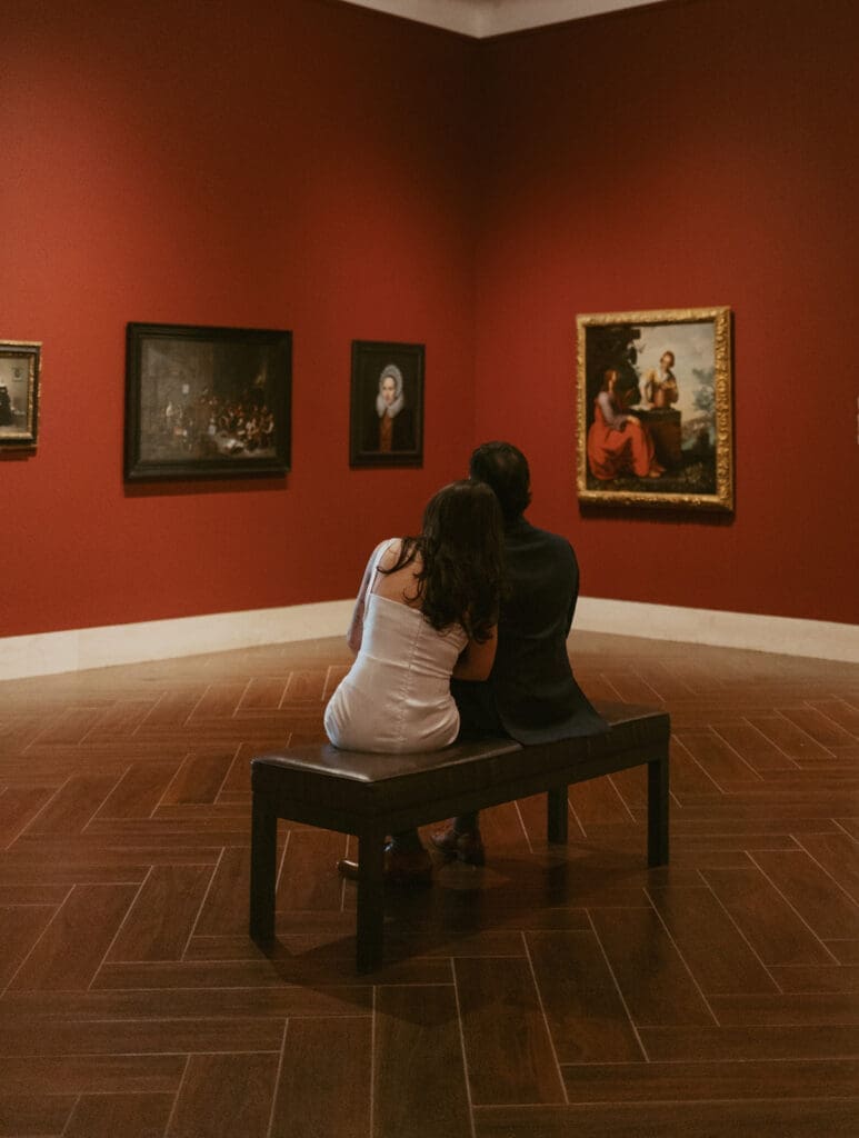 elegant couple gazing at art during their engagement photos at the Museum of fine arts