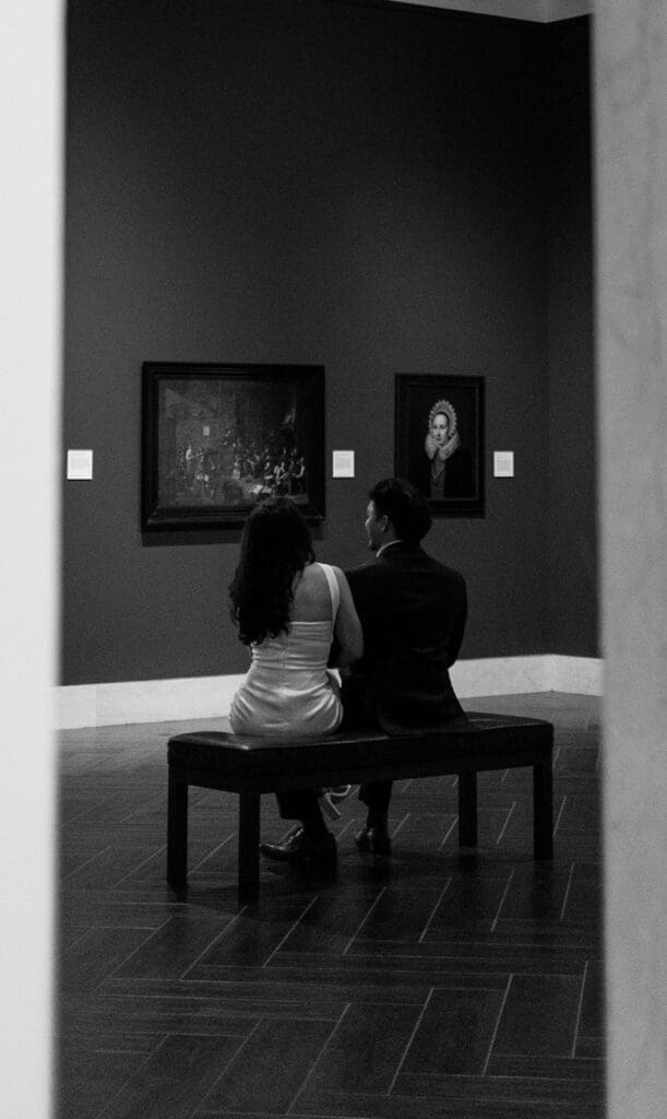 elegant couple gazing at art during their engagement photos at the Museum of fine arts