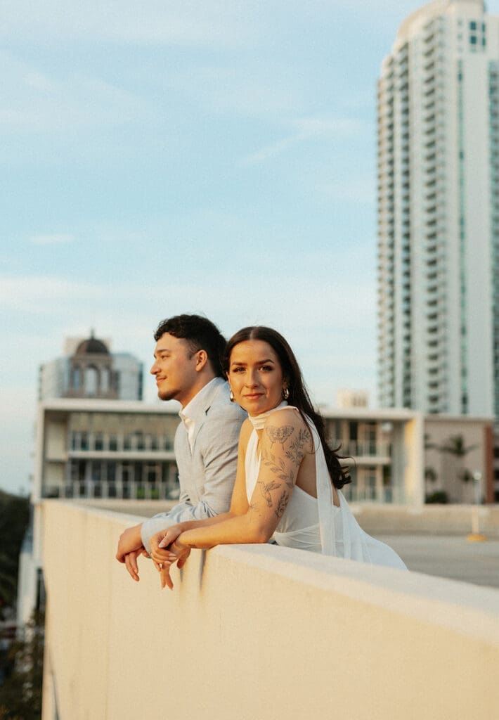 couple posing with city skyline in the background on a garage rooftop in st pete florida