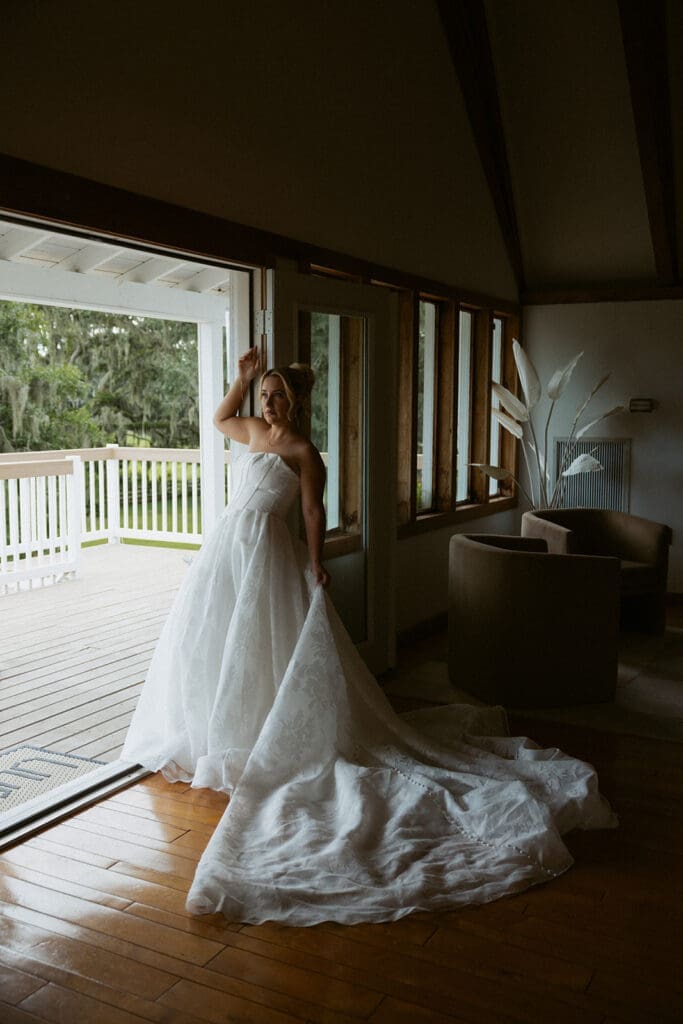 bridal portrait in front of a large window at uliana estate