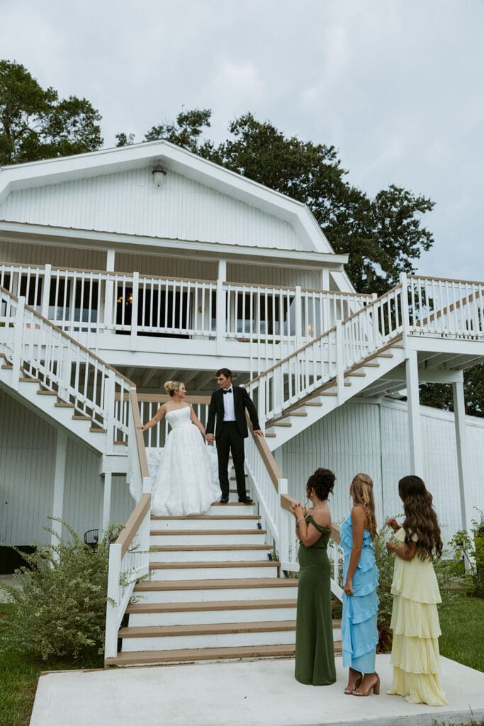 bride and groom on the stairs at uliana estate wedding venue