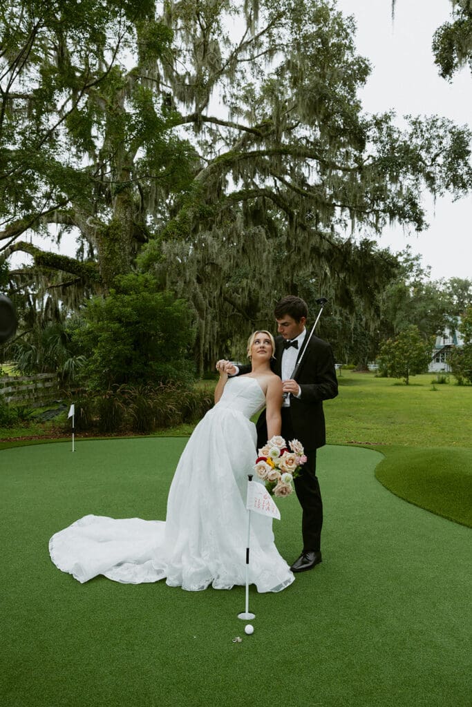 bride and groom posing at the golf course at uliana estate