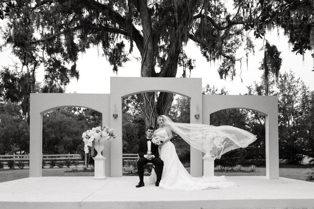 bride and groom posing at the ceremony site at uliana estate