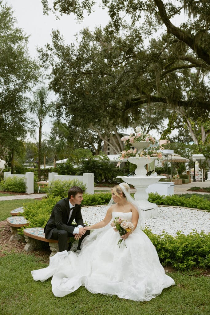 bride and groom in front of an elegant fountain area at uliana estate
