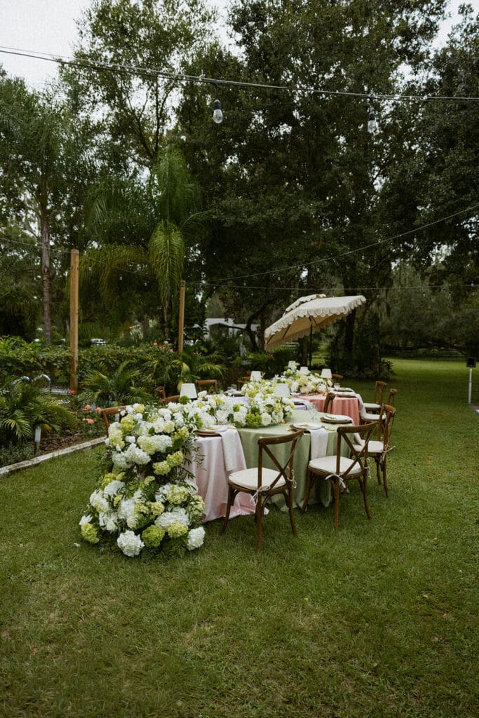 uliana estate outdoor reception space, tables decorated with pastel linens and white floral runners