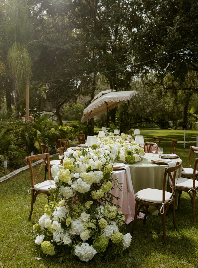uliana estate outdoor reception space, tables decorated with pastel linens and white floral runners
