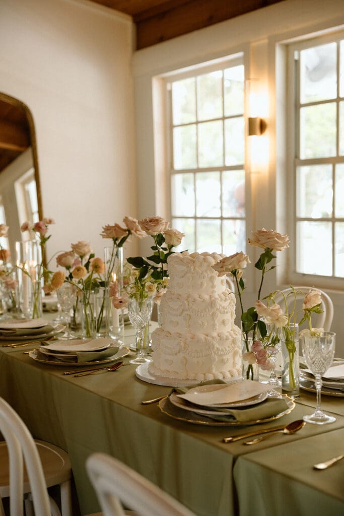 uliana estate indoor reception space, tables decorated with green linens and elegant florals